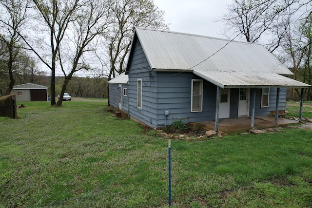view of side of property featuring a yard and metal roof