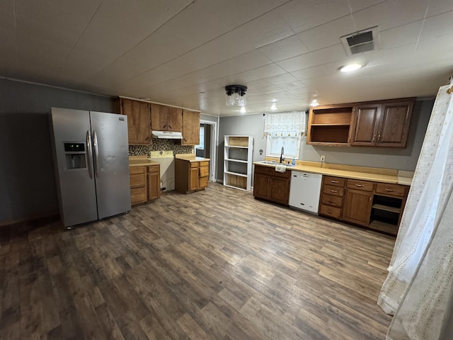 kitchen with visible vents, dishwasher, a sink, stainless steel fridge with ice dispenser, and light countertops