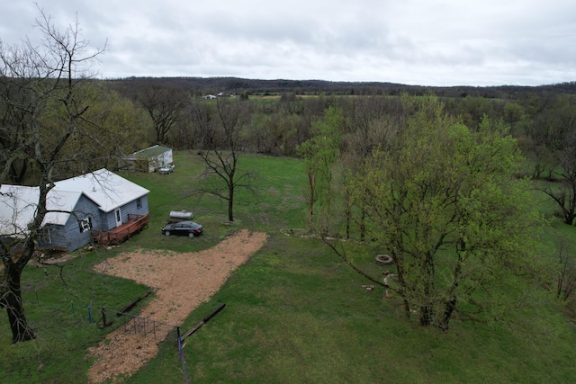 birds eye view of property featuring a view of trees