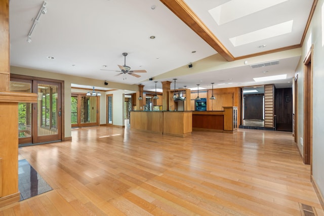 unfurnished living room with visible vents, recessed lighting, light wood finished floors, and a skylight