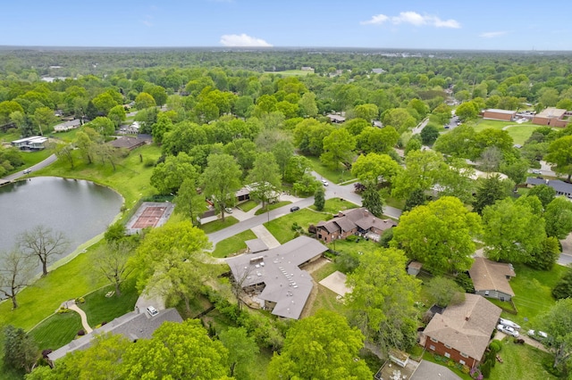 birds eye view of property with a water view, a residential view, and a wooded view