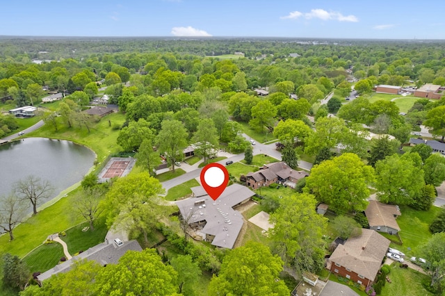 drone / aerial view with a water view, a residential view, and a forest view