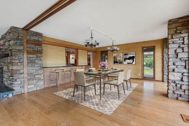 dining space with a notable chandelier and wood finished floors