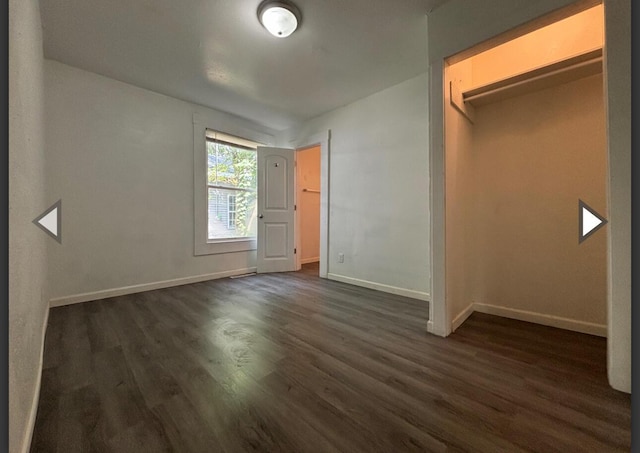 1207 W Florida St, Springfield, MO 65803 - unfurnished bedroom featuring baseboards and dark wood-type flooring