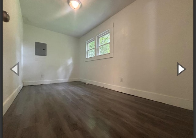 1207 W Florida St, Springfield, MO 65803 - spare room featuring baseboards, electric panel, and dark wood-style flooring
