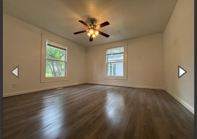 1207 W Florida St, Springfield, MO 65803 - empty room featuring baseboards, a ceiling fan, and dark wood finished floors