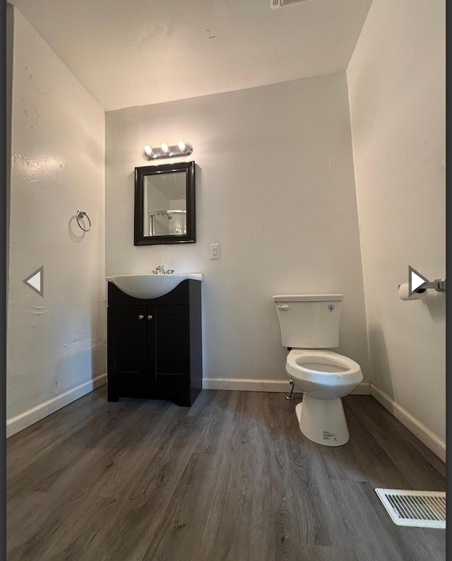 1207 W Florida St, Springfield, MO 65803 - bathroom featuring baseboards, wood finished floors, and vanity