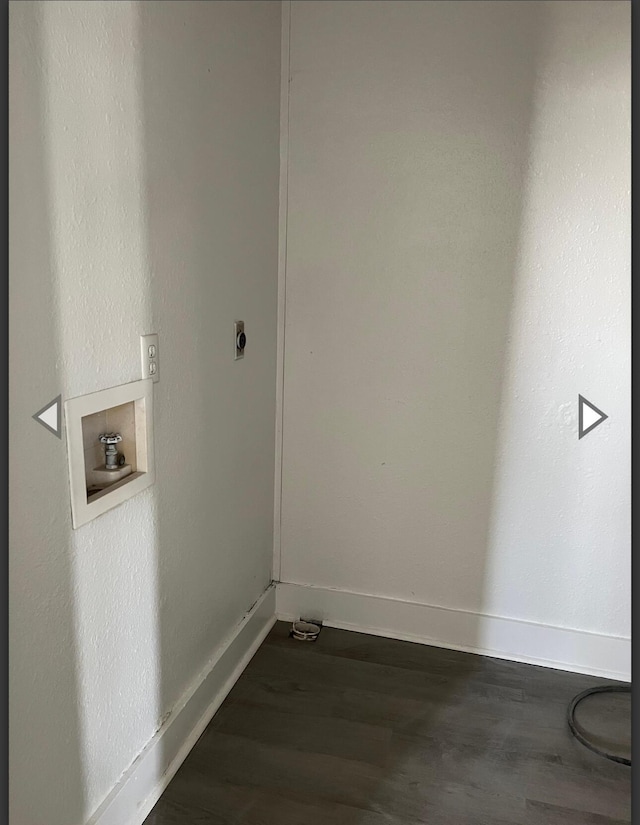 clothes washing area with dark wood-style flooring, washer hookup, laundry area, electric dryer hookup, and baseboards