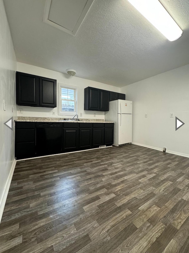 2105 N Elizabeth Ave, Springfield, MO 65803 - unfurnished living room with baseboards, attic access, a textured ceiling, a sink, and dark wood finished floors