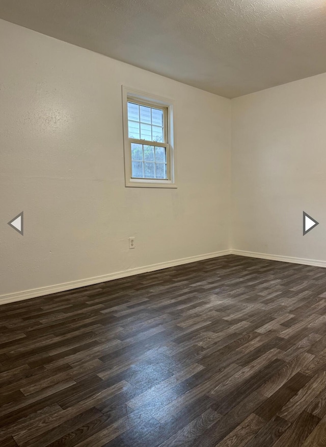 2105 N Elizabeth Ave, Springfield, MO 65803 - spare room with dark wood-type flooring and baseboards
