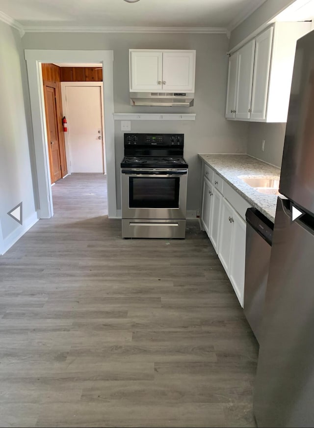 kitchen featuring stainless steel appliances, ornamental molding, and white cabinetry