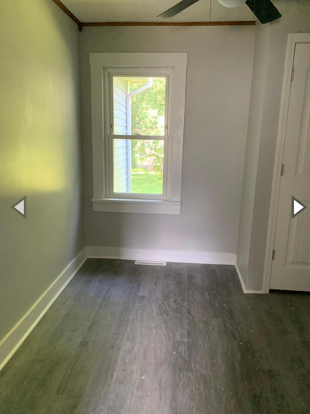 unfurnished room featuring baseboards, ceiling fan, ornamental molding, and wood finished floors