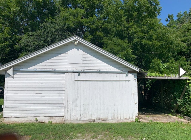 exterior space featuring fence and an outbuilding