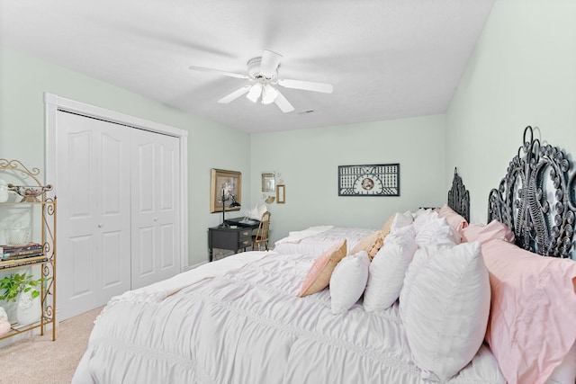 bedroom with carpet floors, ceiling fan, a closet, and visible vents
