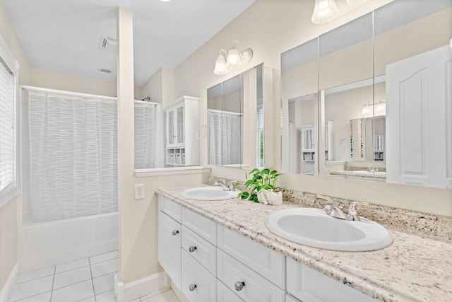 bathroom with baseboards, visible vents, a sink, and tile patterned flooring