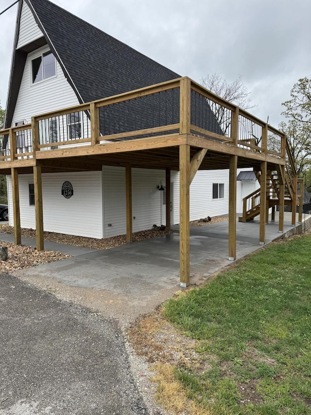1256 Black Oak Resort Ln, Lampe, MO 65681 - exterior space with driveway, a shingled roof, a carport, and a wooden deck