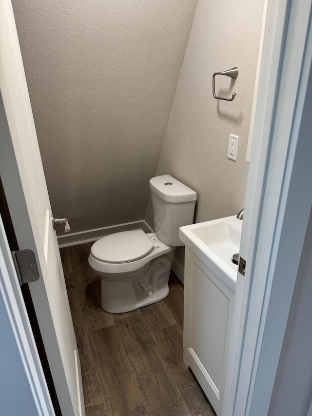 1256 Black Oak Resort Ln, Lampe, MO 65681 - bathroom featuring vanity, baseboards, wood finished floors, and toilet