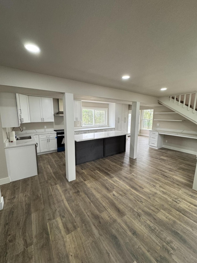 1256 Black Oak Resort Ln, Lampe, MO 65681 - unfurnished living room with stairs, recessed lighting, a wealth of natural light, and dark wood-type flooring