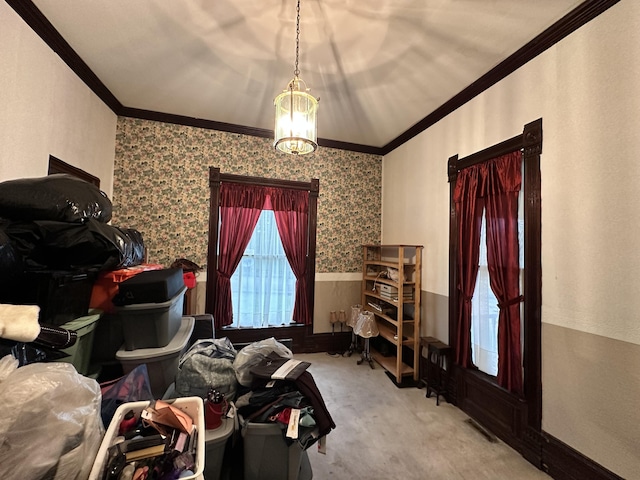 interior space featuring an inviting chandelier, ornamental molding, and a wainscoted wall