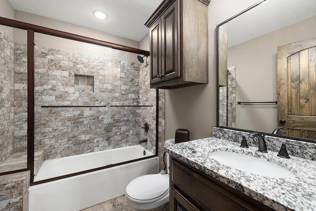 full bathroom with vanity, enclosed tub / shower combo, and toilet
