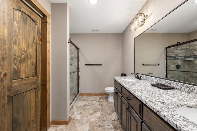 bathroom featuring baseboards, visible vents, a sink, and a stall shower