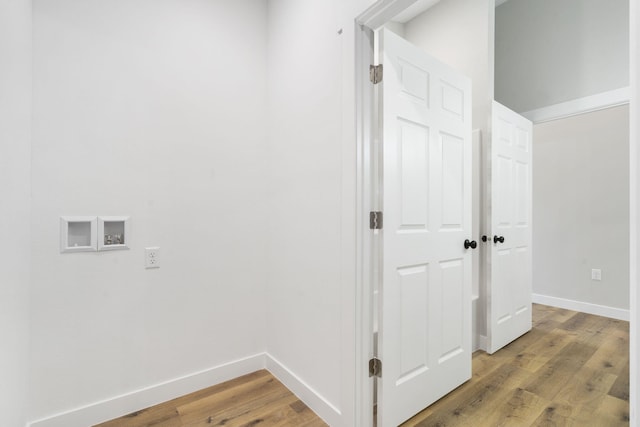 corridor featuring baseboards and light wood-style flooring