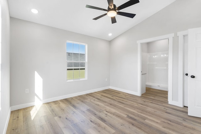 unfurnished bedroom with wood finished floors, recessed lighting, baseboards, and lofted ceiling