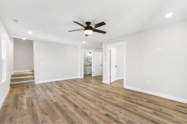 interior space with stairway, ceiling fan, baseboards, and light wood finished floors