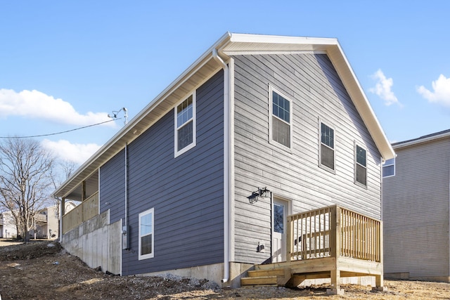 rear view of property featuring a deck