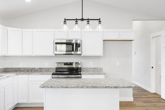 kitchen featuring white cabinetry, appliances with stainless steel finishes, and vaulted ceiling