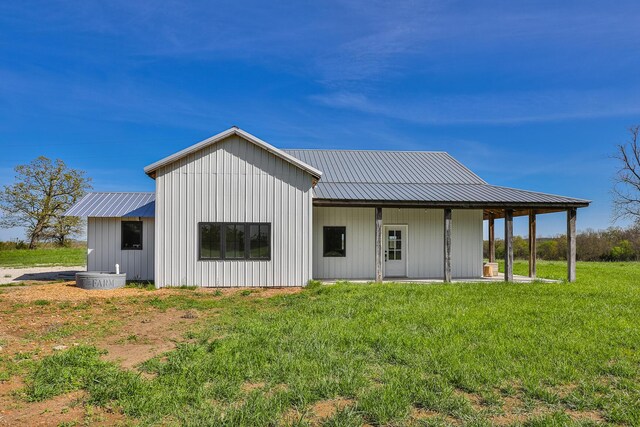 2107 E 530th Rd, Pleasant Hope, MO 65725 - back of house featuring a lawn, board and batten siding, and metal roof