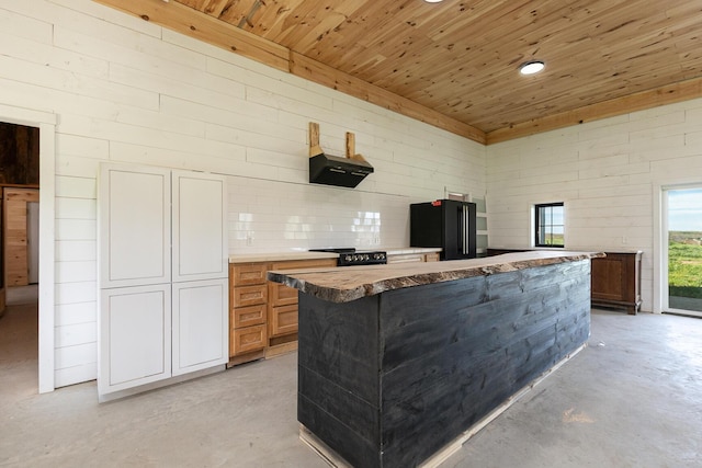 2107 E 530th Rd, Pleasant Hope, MO 65725 - kitchen featuring finished concrete floors, freestanding refrigerator, wooden ceiling, and a center island