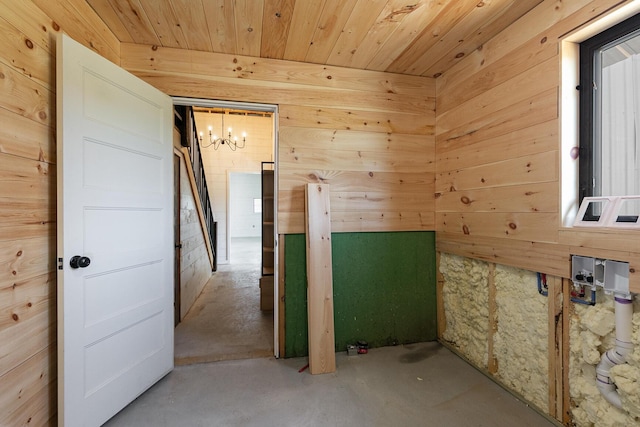 2107 E 530th Rd, Pleasant Hope, MO 65725 - interior space featuring an inviting chandelier, concrete floors, wooden walls, and wood ceiling