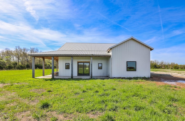 2107 E 530th Rd, Pleasant Hope, MO 65725 - rear view of house featuring a lawn, board and batten siding, a patio area, and metal roof