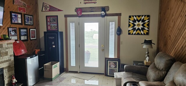 foyer entrance featuring a fireplace and light floors