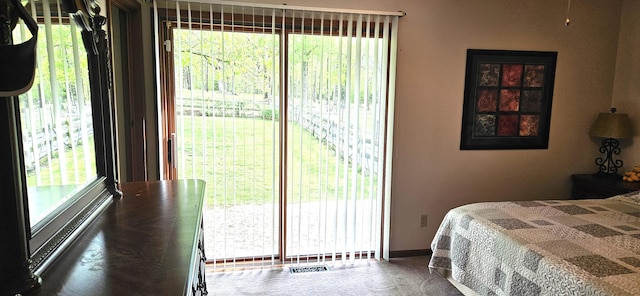 bedroom featuring baseboards, multiple windows, and visible vents