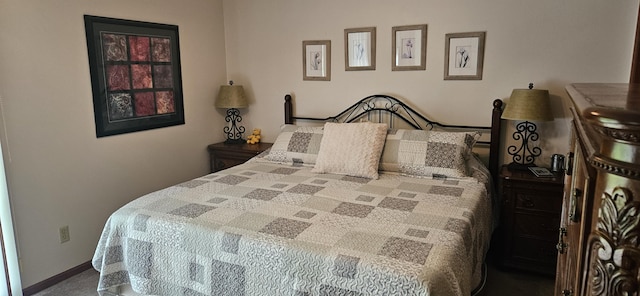 bedroom with baseboards and carpet floors