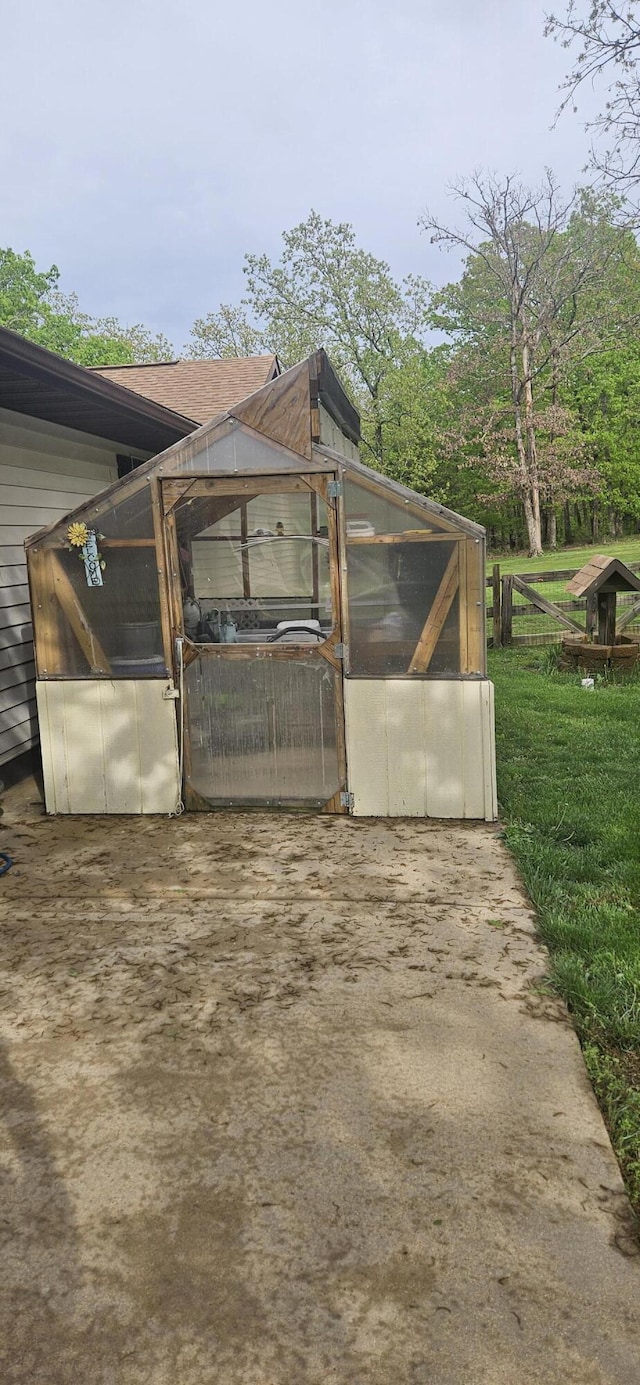 view of home's exterior with an exterior structure and an outdoor structure