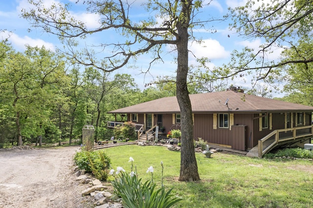 exterior space with a porch, a yard, and driveway