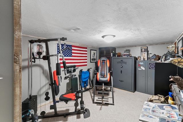exercise room with visible vents and a textured ceiling