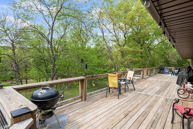 deck featuring outdoor dining space and area for grilling