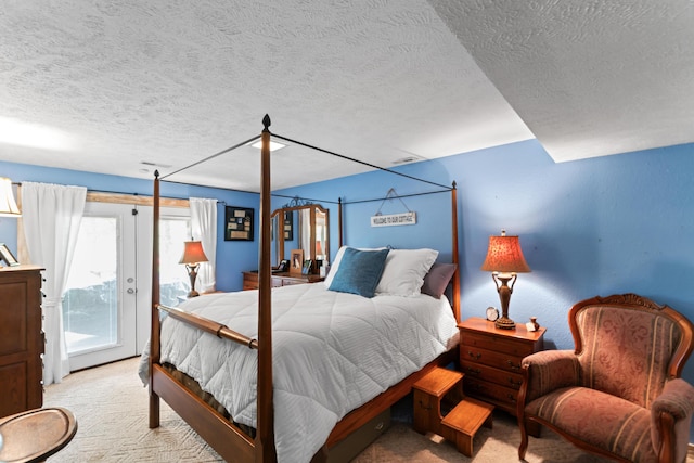 carpeted bedroom featuring access to outside and a textured ceiling