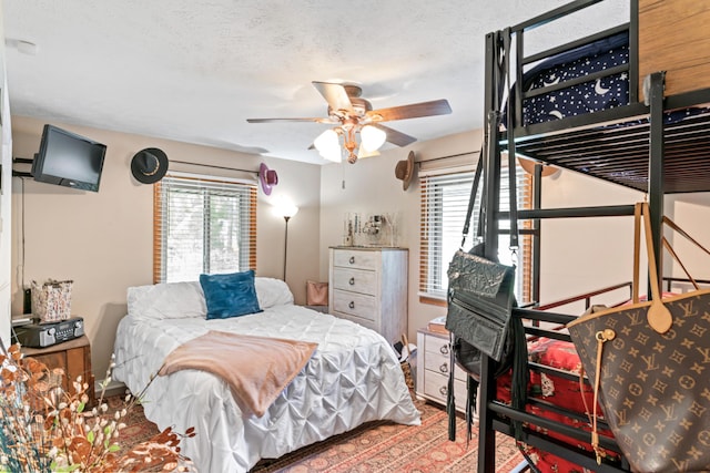 bedroom featuring a textured ceiling and ceiling fan
