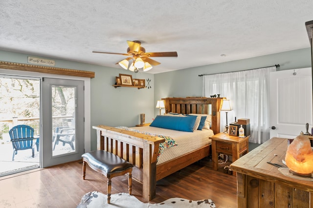 bedroom featuring access to outside, a textured ceiling, a ceiling fan, and dark wood-type flooring