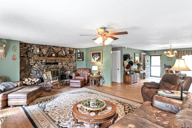 living room with ceiling fan with notable chandelier and wood finished floors