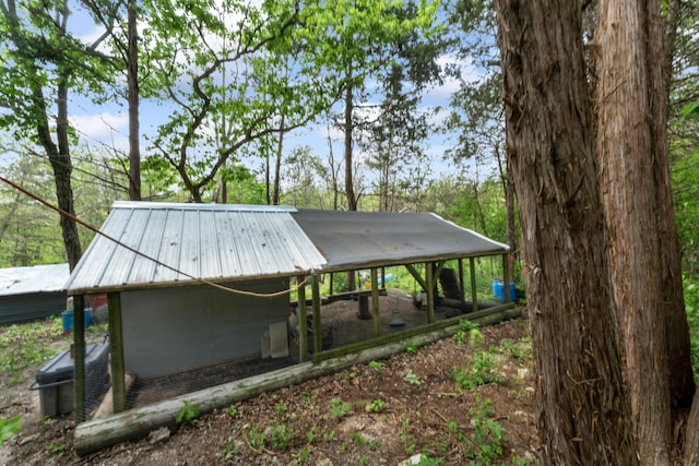 exterior space featuring exterior structure and metal roof