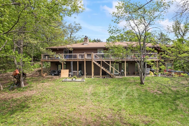 back of house with a yard, a wooden deck, stairs, and a chimney
