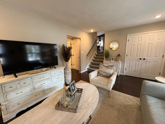 living room featuring stairway, baseboards, recessed lighting, and wood finished floors