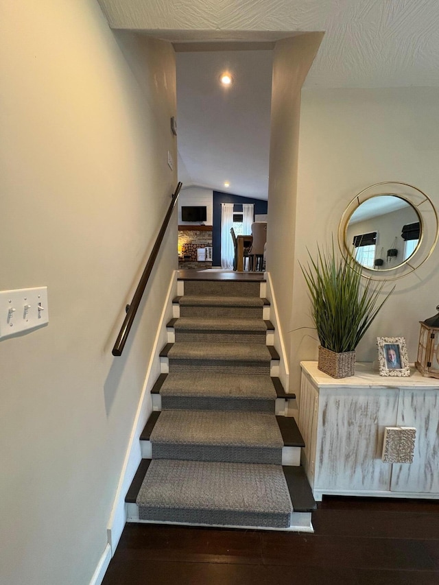 staircase featuring recessed lighting, baseboards, and wood finished floors