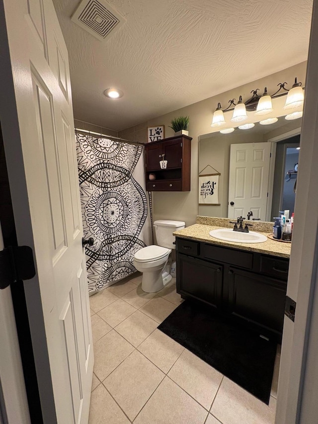 bathroom featuring toilet, tile patterned floors, visible vents, and vanity